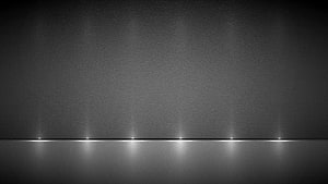 Minimalist Grey Horizon with Soft Light Reflections on a Dark Textured Surface HD wallpaper