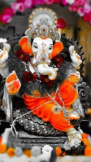 Ornate Ganesha Murti Adorned With Jewels And Marigold Garland HD phone wallpaper