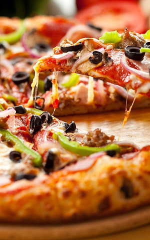 Close-up of a freshly baked pizza slice with melted cheese, black olives, red onions, and green peppers HD phone wallpaper