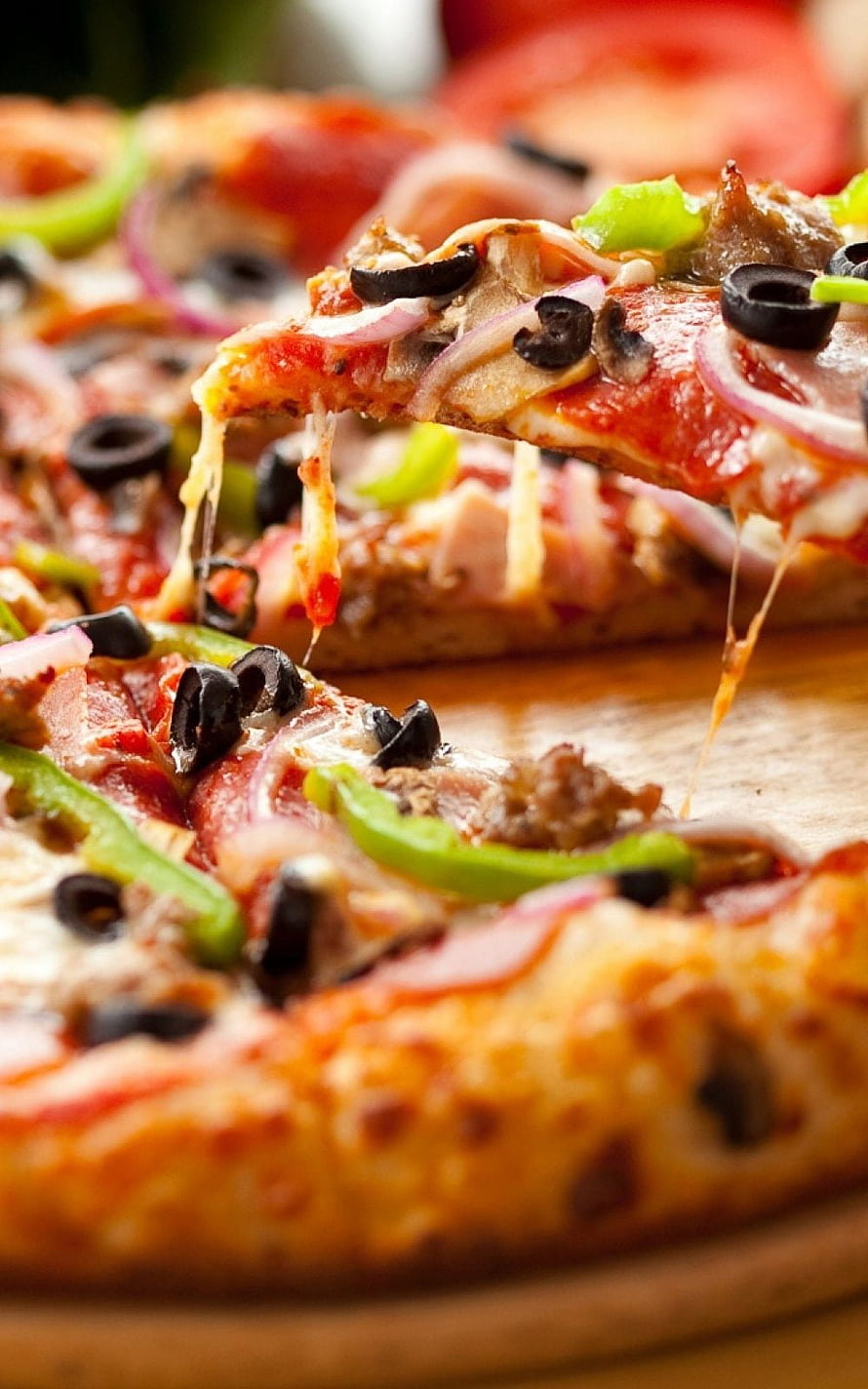 Close-up of a freshly baked pizza slice with melted cheese, black olives, red onions, and green peppers HD phone wallpaper
