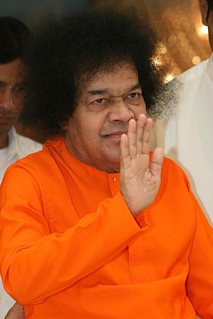 Sathya Sai Baba Waving in Orange Kurta at Public Event HD phone wallpaper