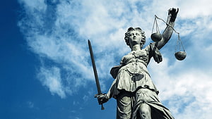 Lady Justice Statue Holding Scales and Sword Against Blue Sky HD wallpaper