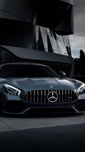 Matte Black Mercedes-AMG GT Front View Parked Before Modern Glass Architecture HD phone wallpaper
