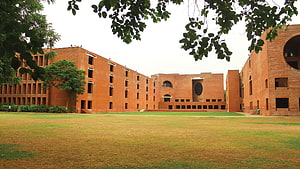 IIM Ahmedabad Campus Courtyard with Red Brick Architecture and Green Lawn HD wallpaper