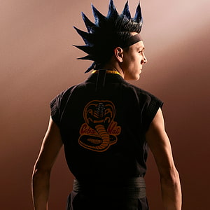 Hawk from Cobra Kai in black gi with spiky hair and headband, studio portrait HD phone wallpaper