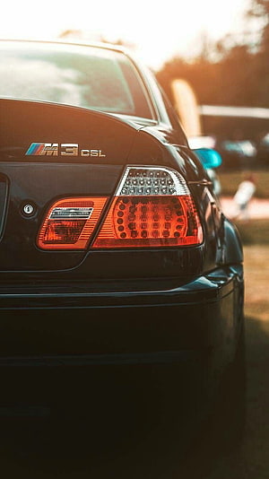Rear Taillight Detail of a Black BMW M3 CSL E46 Sedan at Golden Hour HD phone wallpaper