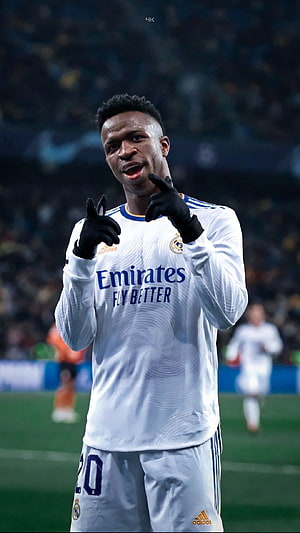 Vinicius Junior in Real Madrid White Home Kit Pointing at Camera on the Pitch HD phone wallpaper