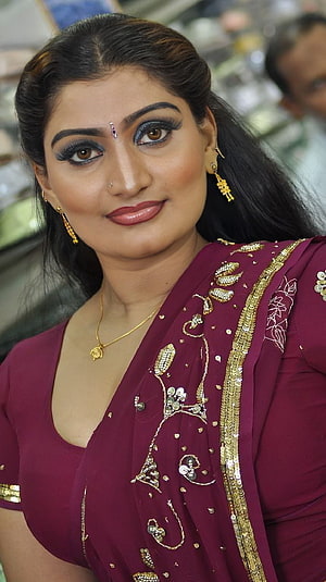 Babilona in a maroon embroidered sari with gold jewelry and traditional makeup HD phone wallpaper