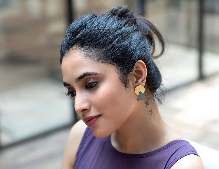Priyanka Arul Mohan Profile Portrait with Messy Bun and Geometric Earrings HD wallpaper