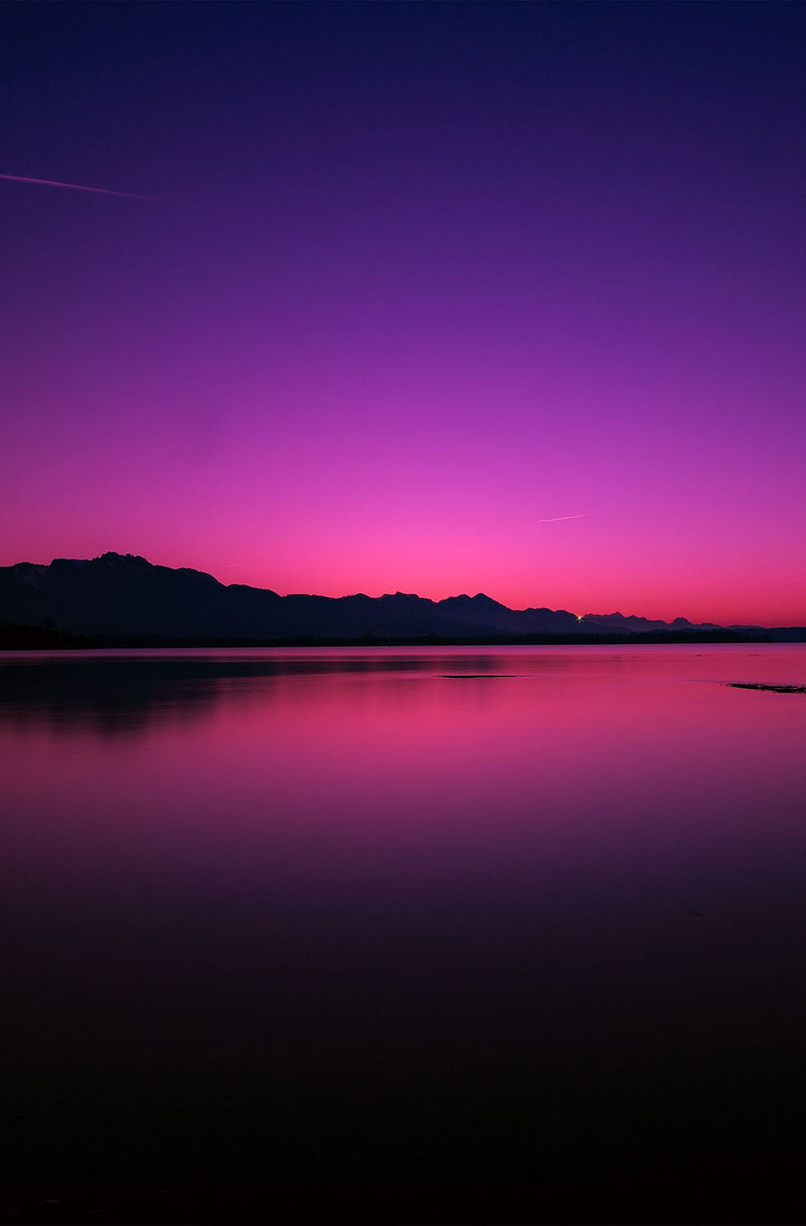 Vivid Purple and Pink Twilight Sky Over a Calm Lake with Mountain Silhouettes HD phone wallpaper