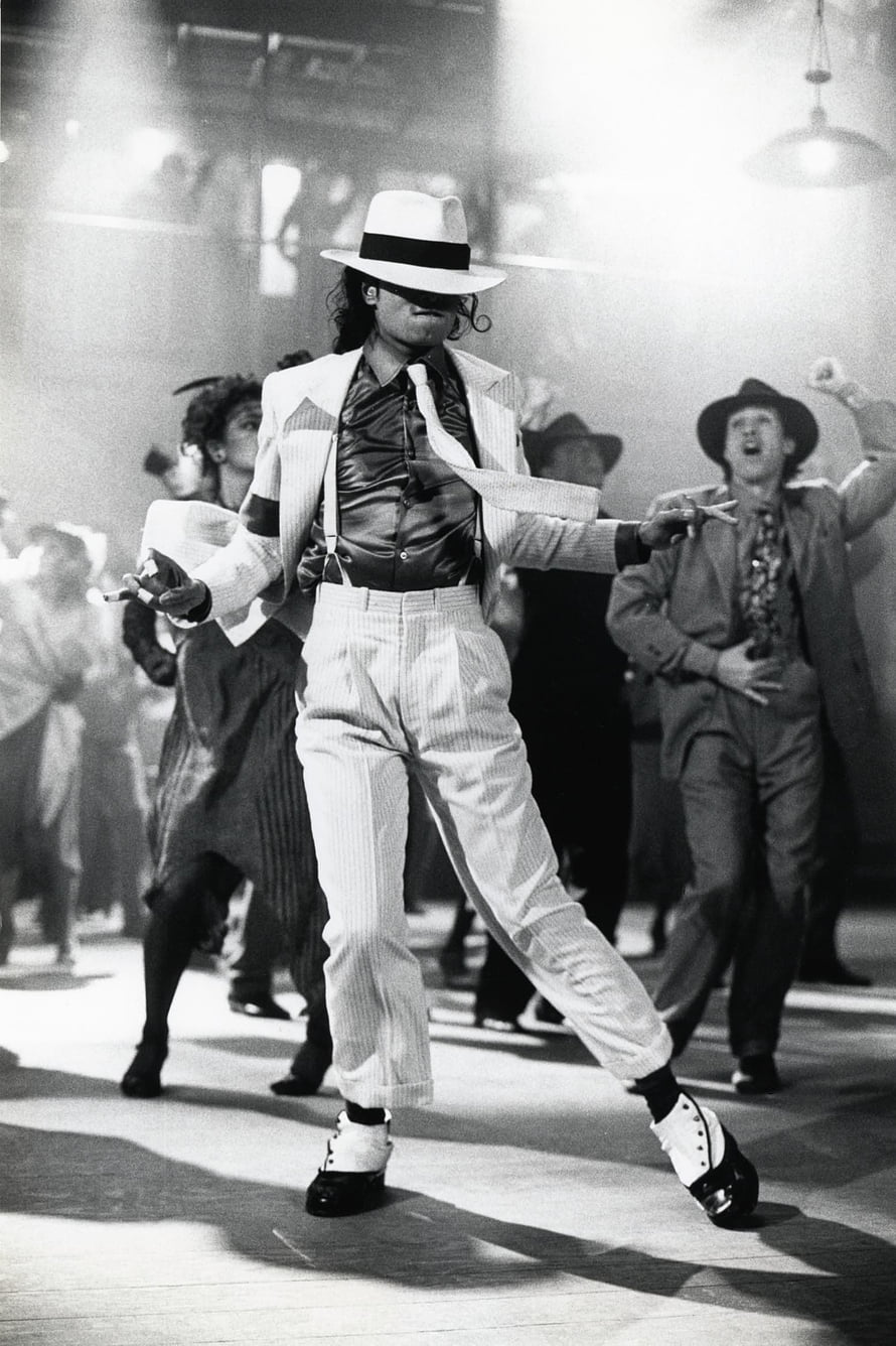 Michael Jackson performing the Smooth Criminal dance move in a white suit and fedora on stage HD phone wallpaper