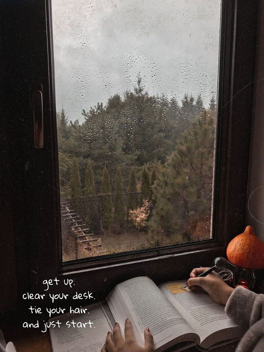Cozy Rainy Day Study Session by the Window with Open Book and Motivational Quote HD phone wallpaper