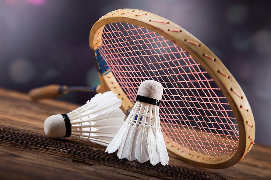 Vintage wooden badminton racket with shuttlecocks on rustic wooden surface HD wallpaper