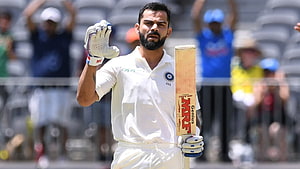 Virat Kohli in white Test cricket kit holding MRF bat and acknowledging crowd HD wallpaper