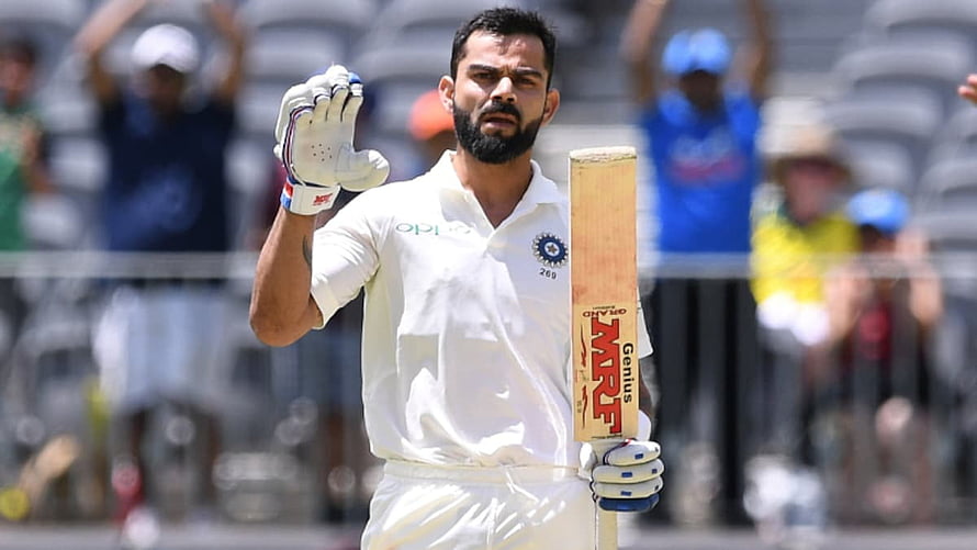Virat Kohli in white Test cricket kit holding MRF bat and acknowledging crowd HD wallpaper