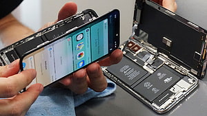 Hands Performing Smartphone Battery Replacement and Internal Component Repair HD wallpaper