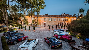 Luxury Bugatti Supercars Parked in a Historic European Mansion Courtyard at Dusk HD wallpaper