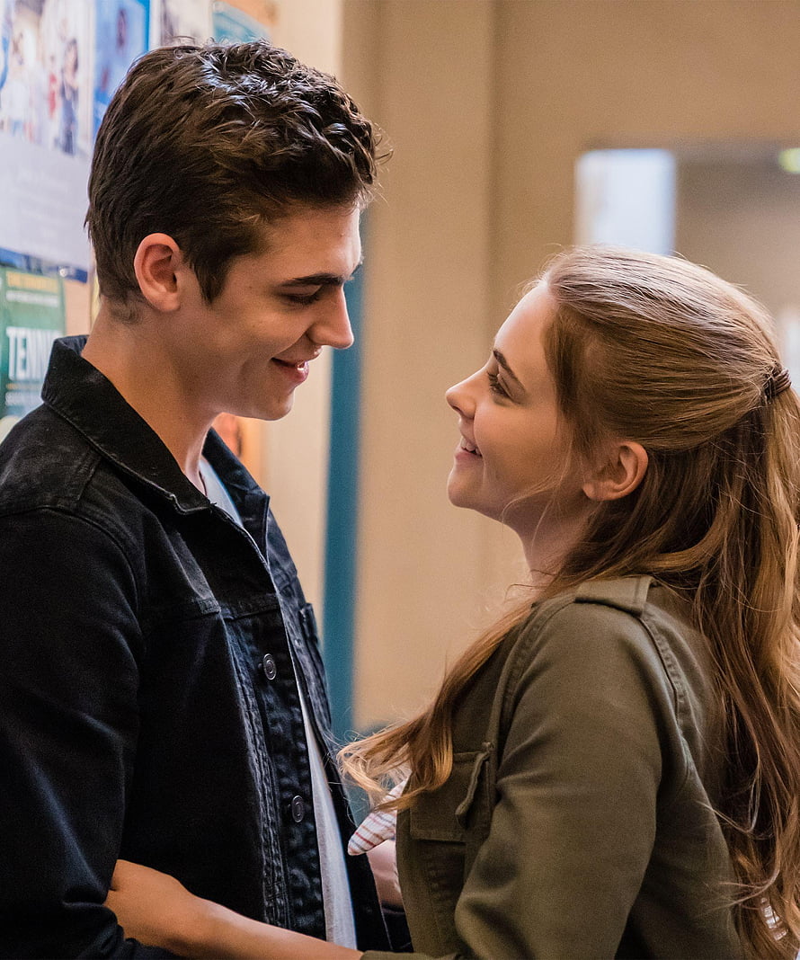 Tessa Young and Hardin Scott sharing a tender moment in a school hallway HD phone wallpaper