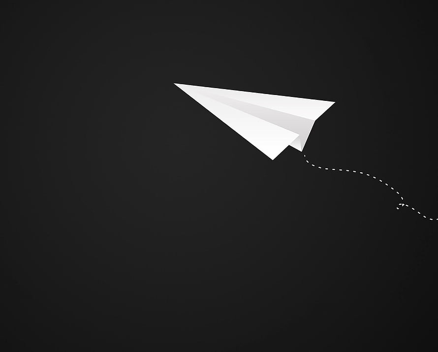 Minimalist White Paper Airplane with Dotted Flight Trail on Dark Background HD wallpaper