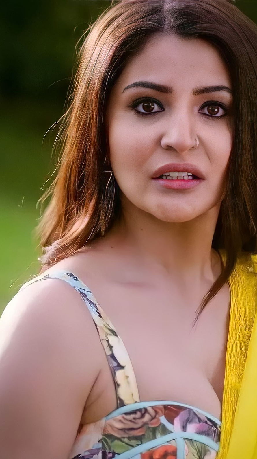 Anushka Sharma in a floral blouse and yellow saree with a natural outdoor backdrop HD phone wallpaper