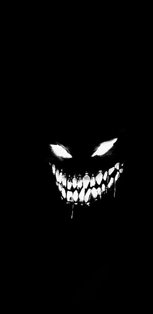 Menacing Grinning Face with Glowing Eyes in Pitch Black Darkness HD phone wallpaper
