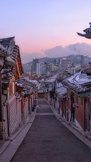 Bukchon Hanok Village at Dusk with Seoul Skyline and Namsan Tower in the Distance HD phone wallpaper