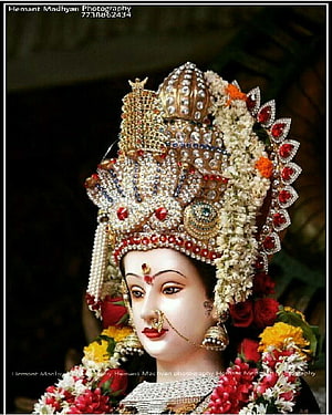 Ornate Durga Goddess Murti Adorned with Jewels and Floral Garlands HD phone wallpaper