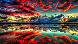 Vivid Red Clouds Reflected in Shallow Tidal Pools at Sunset HD wallpaper