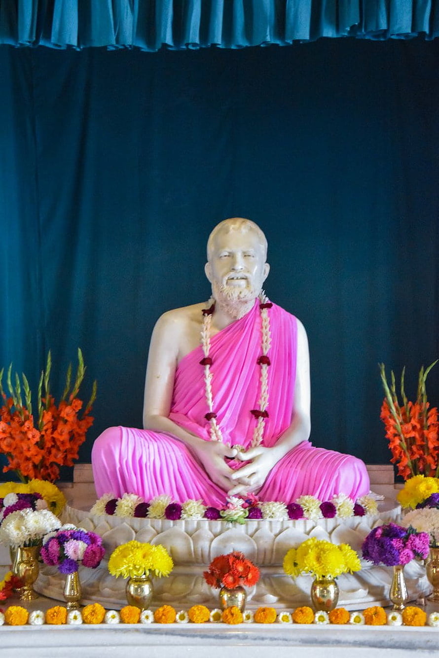 Sri Ramakrishna Statue in Pink Robes at Belur Math with Floral Offerings HD phone wallpaper