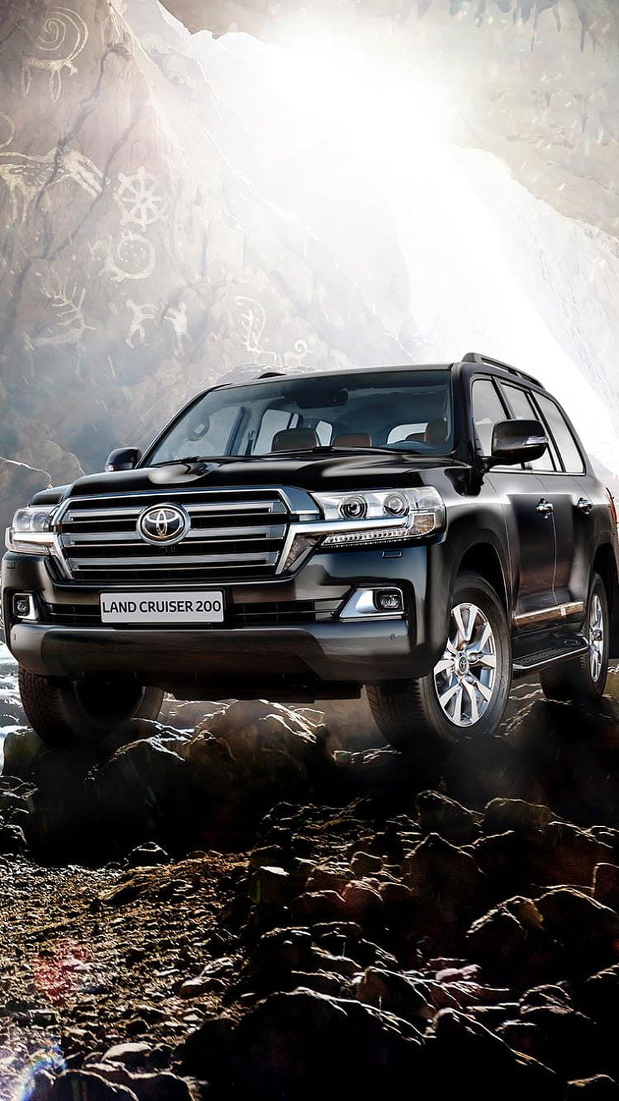 Black Toyota Land Cruiser 200 SUV on Rocky Terrain with Ancient Rock Art Background HD phone wallpaper