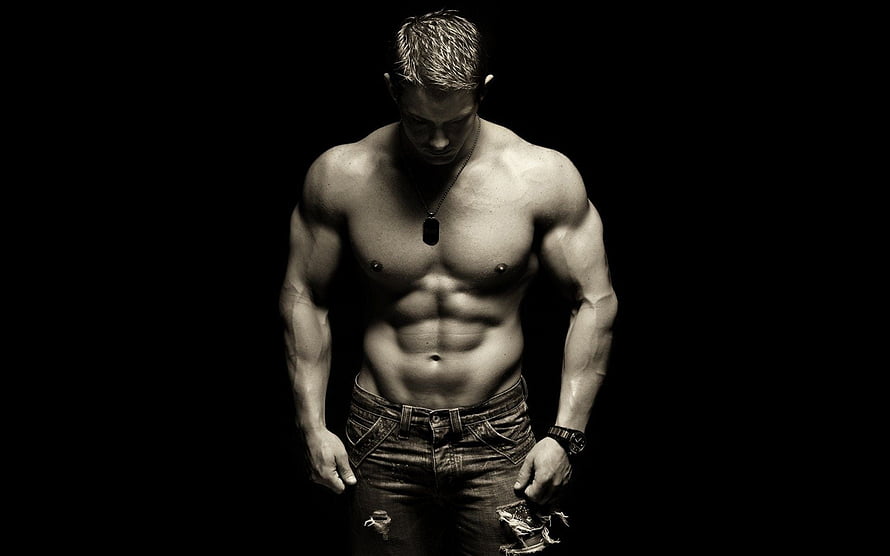 Muscular Male Physique Portrait in Dramatic Black and White Studio Lighting HD wallpaper