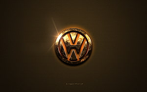 Volkswagen emblem with golden glow on dark textured metal surface HD wallpaper