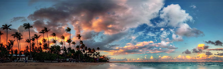 Tropical Beach Panorama with Silhouetted Palm Trees and Dramatic Sunset Sky HD wallpaper