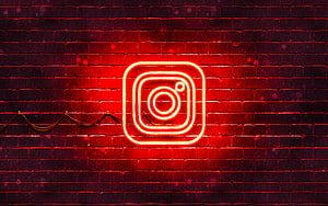 Glowing red Instagram neon sign mounted on a dark brick wall with dramatic lighting HD wallpaper