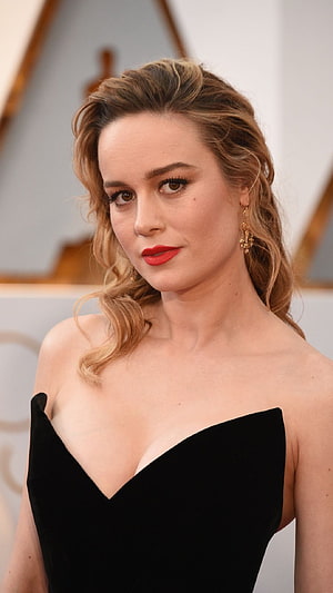 Brie Larson in Black Strapless Gown with Red Lipstick and Gold Earrings HD phone wallpaper