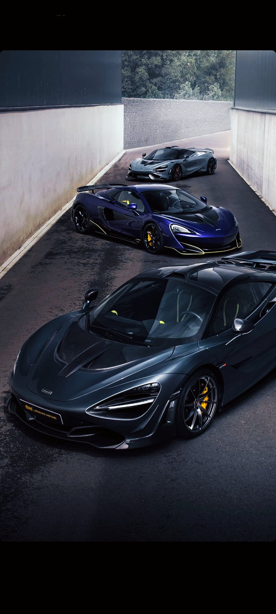 McLaren 720S, 765LT, and 600LT Supercars Lined Up in a Concrete Tunnel HD phone wallpaper