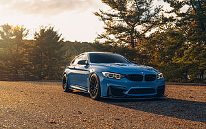 Blue BMW M4 F82 Coupe Parked on Gravel at Golden Hour HD wallpaper