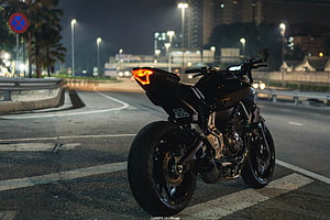 Black Yamaha MT-07 Motorcycle Parked on City Street at Night HD wallpaper