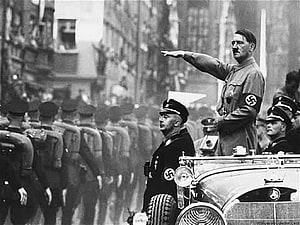 Adolf Hitler Gesturing During a Military Parade in a Vintage Black and White Photograph HD wallpaper