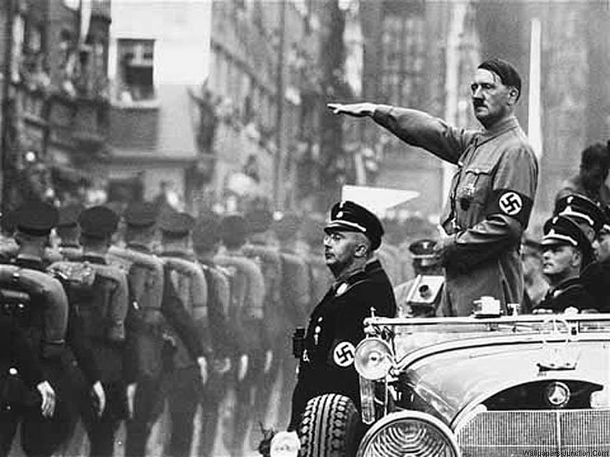 Adolf Hitler Gesturing During a Military Parade in a Vintage Black and White Photograph HD wallpaper