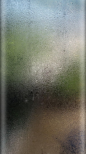 Rainy Day View Through Frosted Glass with Soft Green and Warm Tones HD phone wallpaper