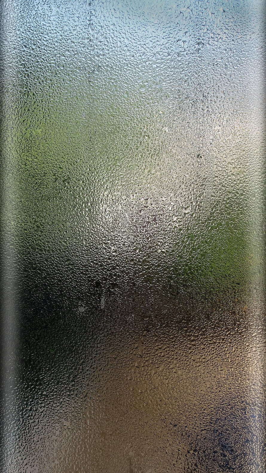 Rainy Day View Through Frosted Glass with Soft Green and Warm Tones HD phone wallpaper