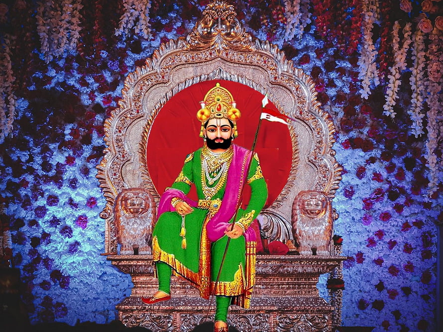 Ramdev Pir Seated on Ornate Throne with Lion Guardians and Floral Backdrop HD wallpaper