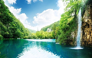 Serene Tropical Waterfall Cascading Into a Turquoise Mountain Lake HD wallpaper