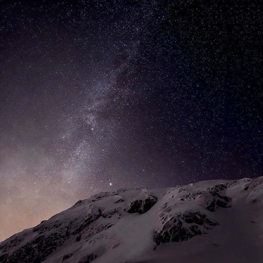 Milky Way Galaxy Arching Over Snow-Capped Mountain Ridge at Night HD phone wallpaper