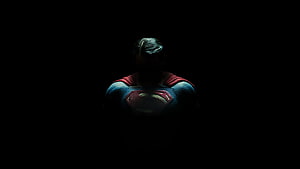 Superman in Dark Suit with Glowing Emblem Against Black Background HD wallpaper
