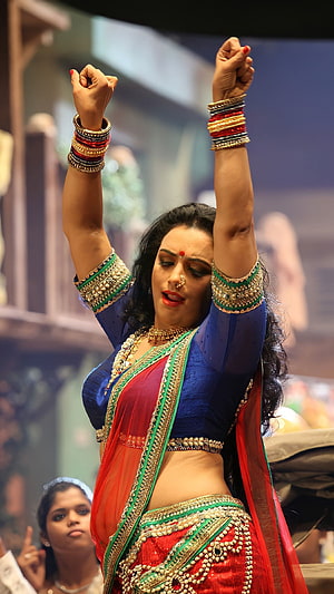 Swetha Menon in Traditional Indian Attire with Arms Raised on Stage HD phone wallpaper