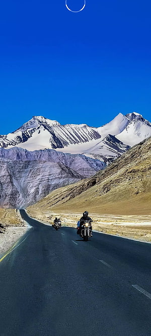 Motorcyclists Riding on a Desert Highway Through the Snow-Capped Mountains of Leh Ladakh HD phone wallpaper