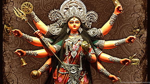 Goddess Durga Multi-Armed Statue with Traditional Silver Jewelry and Sacred Weapons HD wallpaper