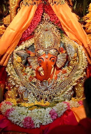 Ornate Lord Ganesha Murti Adorned With Jewels And Flower Garlands HD phone wallpaper